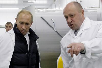 Yevgeny Prigozhin shows Russian Prime Minister Vladimir Putin his school lunch factory outside Saint Petersburg in 2010.  The death of Yevgeny Prigozhin, head of the Wagner paramilitary group, following a plane crash on August 23, 2023 has been confirmed by formal genetic analysis, Russia's Investigative Committee said. (Photo by Alexey DRUZHININ  /  SPUTNIK  /  AFP)