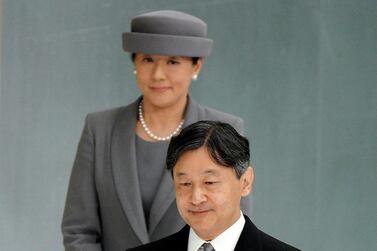 Japanese Emperor Naruhito, accompanied by Empress Masako, walks to deliver his remarks during a memorial ceremony for the war dead at Nippon Budokan Martial Arts Hall in Tokyo. AP