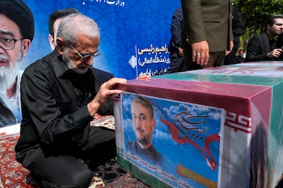 Former Iranian Foreign Minister Kamal Kharrazi pays respect to the flag-draped coffin of the late Foreign Minister Hossein Amirabdollahian during a funeral ceremony in Tehran. AP