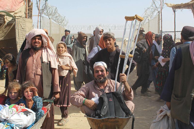 Afghan nationals arrive in Pakistan after crossing the Pakistan-Afghanistan border crossing point in Chaman. AFP