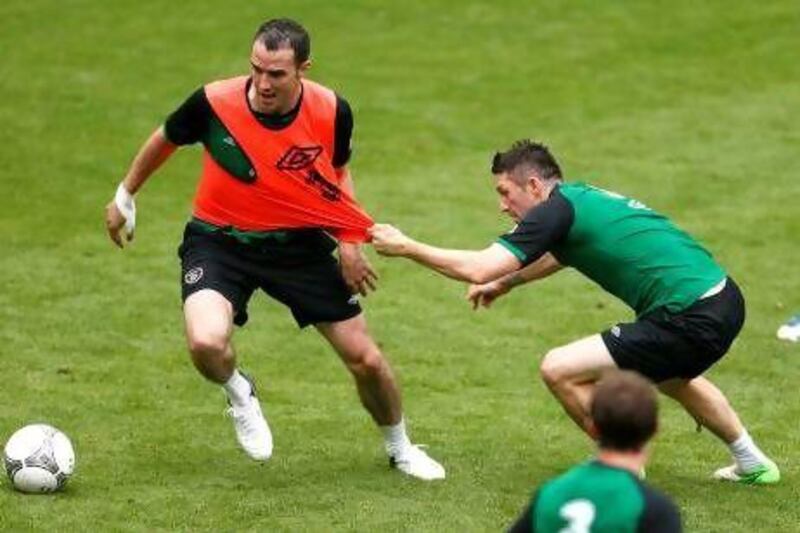 Ireland's John O'Shea, left, is pulled off by Robbie Keane during a training session of Republic of Ireland at the Euro 2012 soccer championship in a stadium in Gdynia Poland, Tuesday, June 12, 2012. (AP Photo/Peter Morrison) *** Local Caption *** Soccer Euro 2012 Training Ireland.JPEG-03a28.jpg