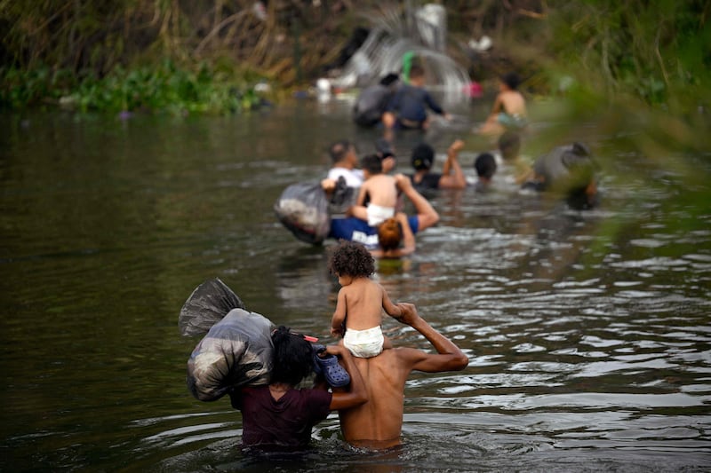 Migrants cross the Rio Grande in Mexico's Tamaulipas state as they try to reach the US. AFP