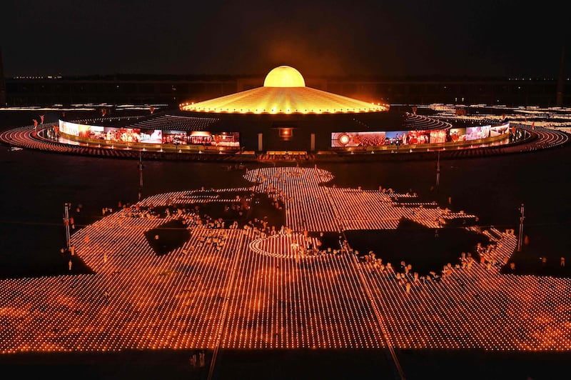 Buddhist monks and devotees light 330,000 candles in an attempt to break the Guinness World Record for the largest flaming image during Earth Day celebrations at the Wat Dhammakaya Buddhist temple on the outskirts of Bangkok.  AFP