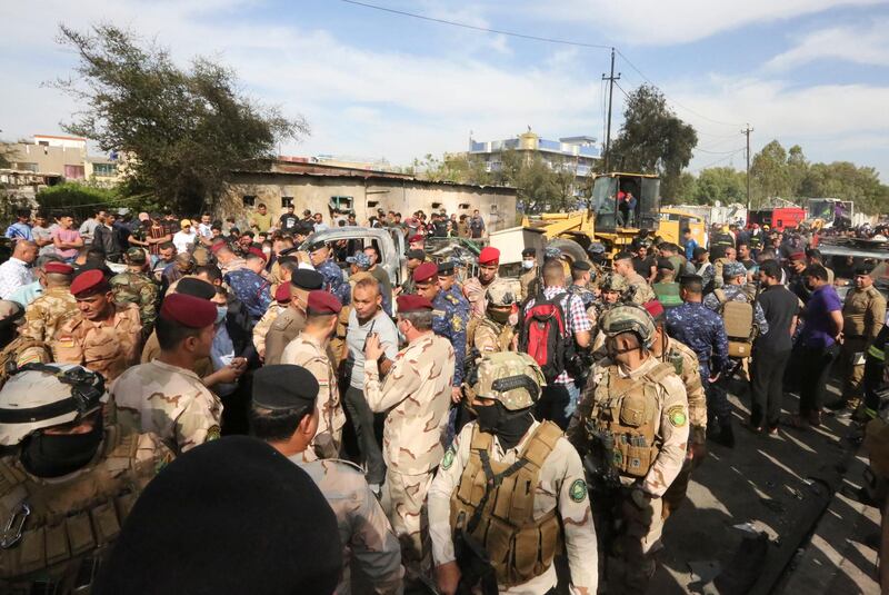 Members of the Iraqi army and security forces gather at the scene of an explosion in the Habibiya district of the Sadr City suburb of Iraq's capital Baghdad on April 15, 2021. - At least one civilian was killed in an explosion in the densely populated Shiite stronghold of Sadr City in eastern Baghdad, the Iraqi army reported, without determining the cause or the perpetrators. (Photo by Sabah ARAR / AFP)