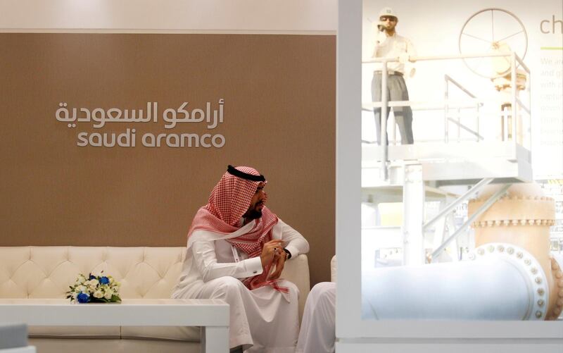 FILE PHOTO: A Saudi Aramco employee sits in the area of its stand at the Middle East Petrotech 2016, an exhibition and conference for the refining and petrochemical industries, in Manama, Bahrain, September 27, 2016. REUTERS/Hamad I Mohammed/File Photo