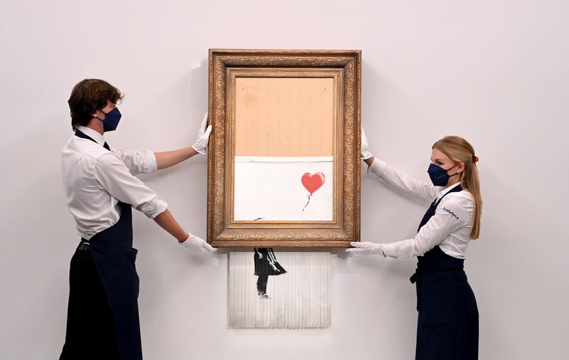 'Love is in the Bin' by Banksy fetched $25.4m at Sotheby's, an artist record price. EPA