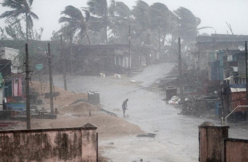 A local stands near Arjipalli beach during rain and strong winds caused by Cyclone Titli. AP Photo