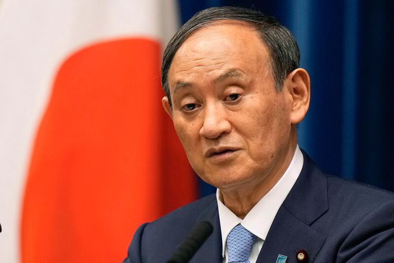 Japanese Prime Minister Yoshihide Suga will pull out of a party leadership race in September. Pool Photo via AP