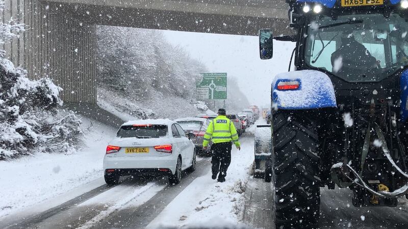 Traffic in snowy conditions in Blackburn, Aberdeenshire. PA
