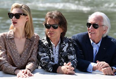 (FromL) Australian actress Elizabeth Debicki, British musician, singer and actor Mick Jagger and Canadian actor Donald Sutherland arrive by taxi boat at the pier of the Palazzo del Casino to attend a photocall for the film "The Burnt Orange Heresy" presented out of competition on September 7, 2019 during the 76th Venice Film Festival at Venice Lido.  / AFP / Alberto PIZZOLI
