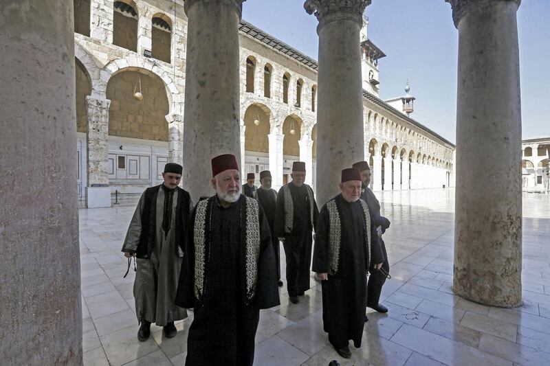 Muezzins, who call Muslims to prayer, arrive at the Umayyad Mosque in the ancient quarters of Damascus. AFP
