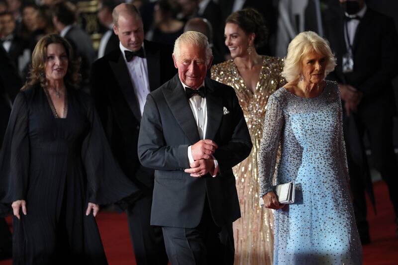 Charles, Price of Wales, and his wife Camilla, the Duchess of Cornwall, walk on the red carpet, followed by producer Barbara Broccoli, Prince William and his wife Kate, the Duchess of Cambridge. Photo: AP