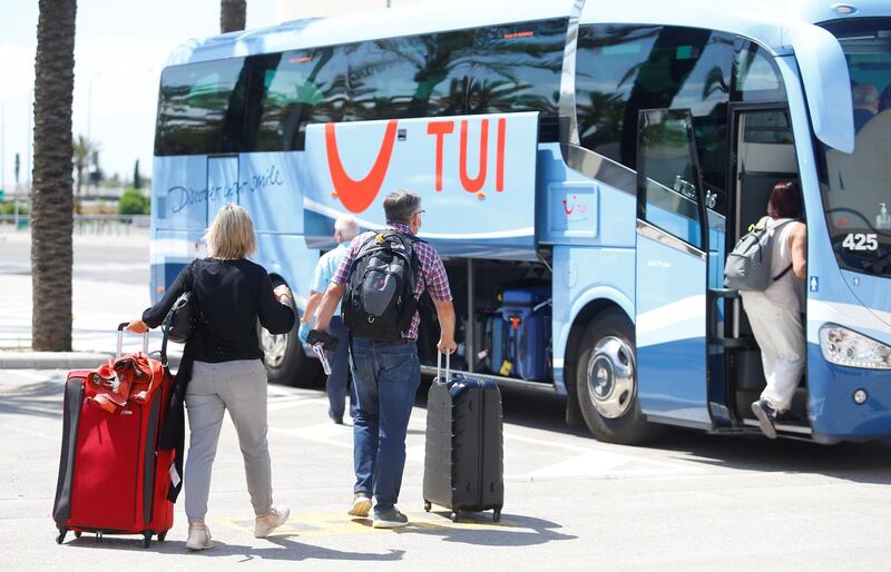 German tourists carry their luggage to a bus upon arrival at the Palma de Mallorca airport, as part of a tourism pilot program before officially reopening the borders after the coronavirus disease (COVID-19) outbreak, in Palma de Mallorca, Spain June 15, 2020. REUTERS/Enrique Calvo