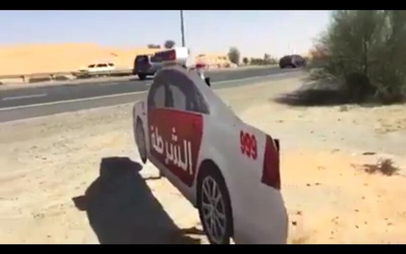 Screengrab taken from a Facebook video showing full size cardboard cutouts of a police cars in UAQ.