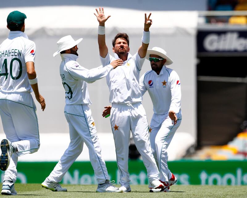 Pakistan's Yasir Shah, center, celebrates after he got the wicket of Australia's Steve Smith during their cricket test match in Brisbane, Australia, Saturday, Nov. 23, 2019. (AP Photo/Tertius Pickard)
