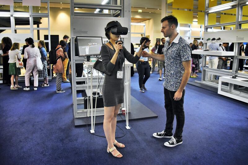 An exhibitor, right, explains his project to a woman attending the Global Grad Show during the Dubai Design Week at the Dubai Design District, Dubai, UAE, on Monday, Nov. 11, 2019. (Photos by Shruti Jain - The National)