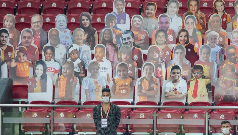 Galatasaray's Radamel Falcao stands in front of cardboard cut-outs with photographs of supporters during the Turkish Super League football match between Galatasaray and Trabzonspor in Istanbul, Turkey. EPA