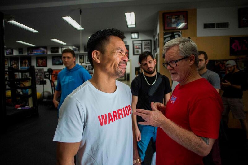 Manny Pacquiao talks to trainer Freddie Roach after an afternoon training session at Wild Card Boxing in Los Angeles. AFP