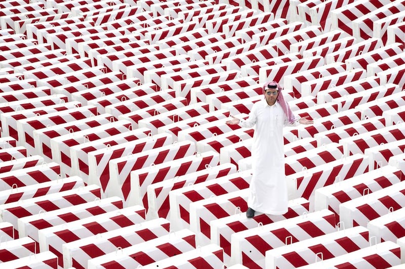 The artist Abdulnassesr Gharem with his concrete blocks installation. Courtesy of Abdulnasser Gharem / Edge of Arabia