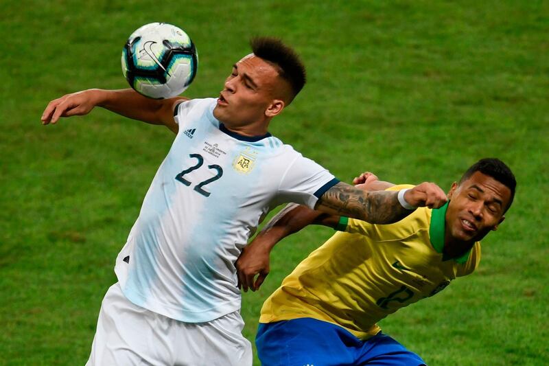 Argentina's Lautaro Martinez and Brazil's Alex Sandro vie for the ball. AFP
