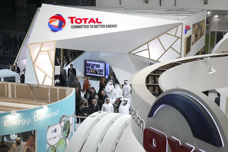 Visitors mingle near the Total stall at the Abu Dhabi International Petroleum Exhibition & Conference in November, 2014, at the Abu Dhabi National Exhibition Centre. Silvia Razgova / The National