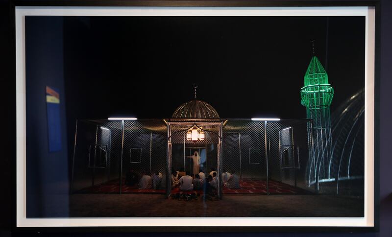 The mosque made of industrial material lights up at night
