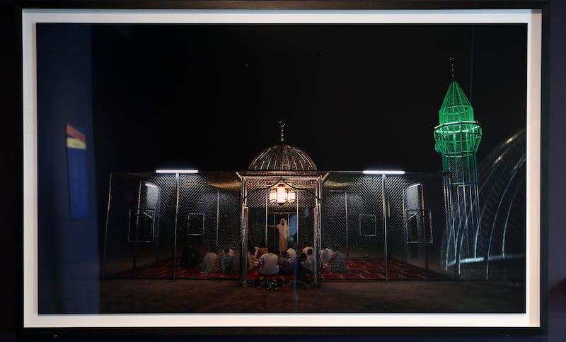 The mosque made of industrial material lights up at night