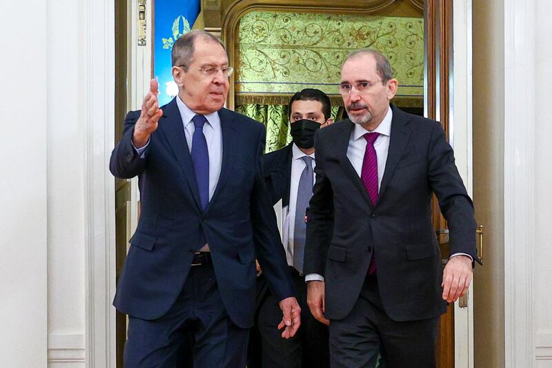In this handout photo released by Russian Foreign Ministry Press Service, Russian Foreign Minister Sergey Lavrov, left, welcomes Jordanian Foreign Minister Ayman for the talks in Moscow, Russia, Wednesday, Feb. 3, 2021. (Russian Foreign Ministry Press Service via AP)