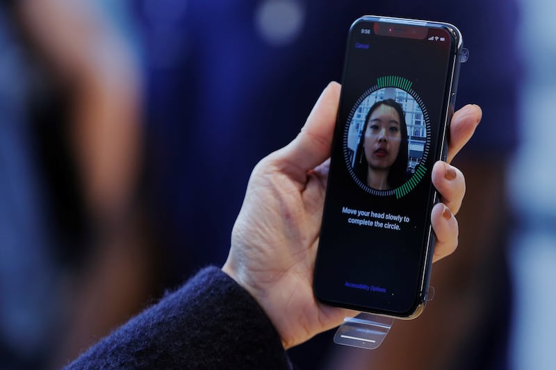 A woman setting up facial recognition on her Apple iPhone X in New York in 2017. Reuters