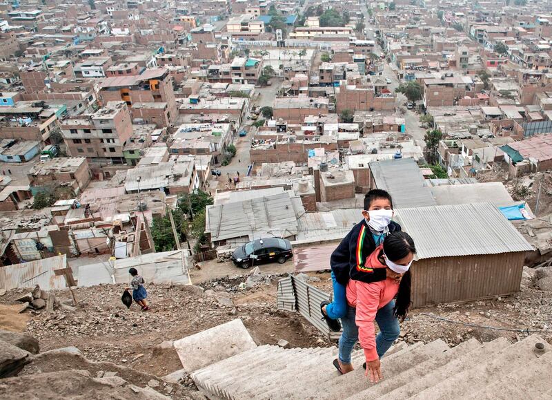 Peruvian Marlith Mori returns to her home on the heights of the Vista Alegre shantytown of the Comas district in the outskirts of Lima.  AFP