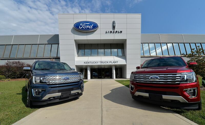 In this Friday, Oct. 27, 2017, photo, vehicles line the entrance to the Ford Kentucky Truck Plant in Louisville, Ky. Ford Motor Co. reports earnings, Wednesday, Jan. 24, 2018. (AP Photo/Timothy D. Easley)