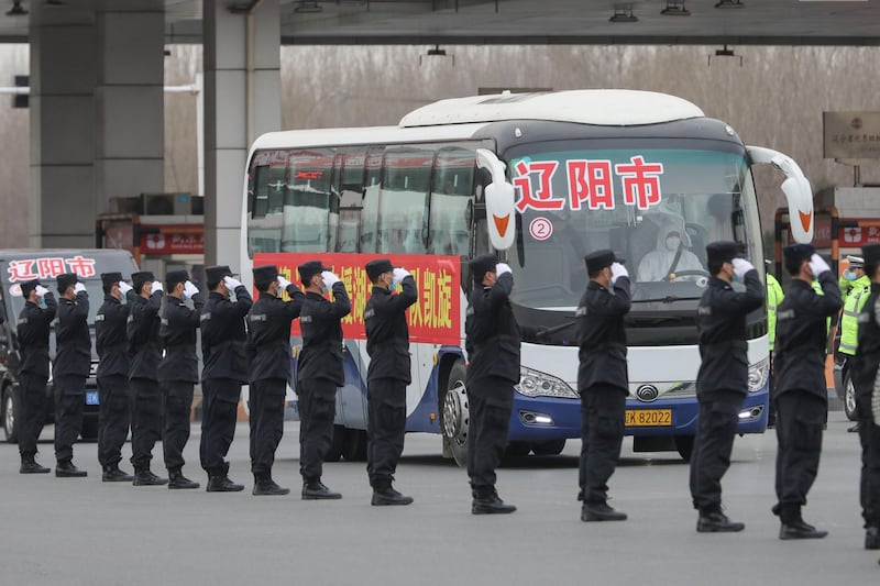Buses carrying members of a medical assistance team from Shenyang leave Shenyang Taoxian Airport upon their return home after helping with the COVID-19 coronavirus recovery effort in Wuhan, in Shenyang in China's northeastern Liaoning province.  AFP