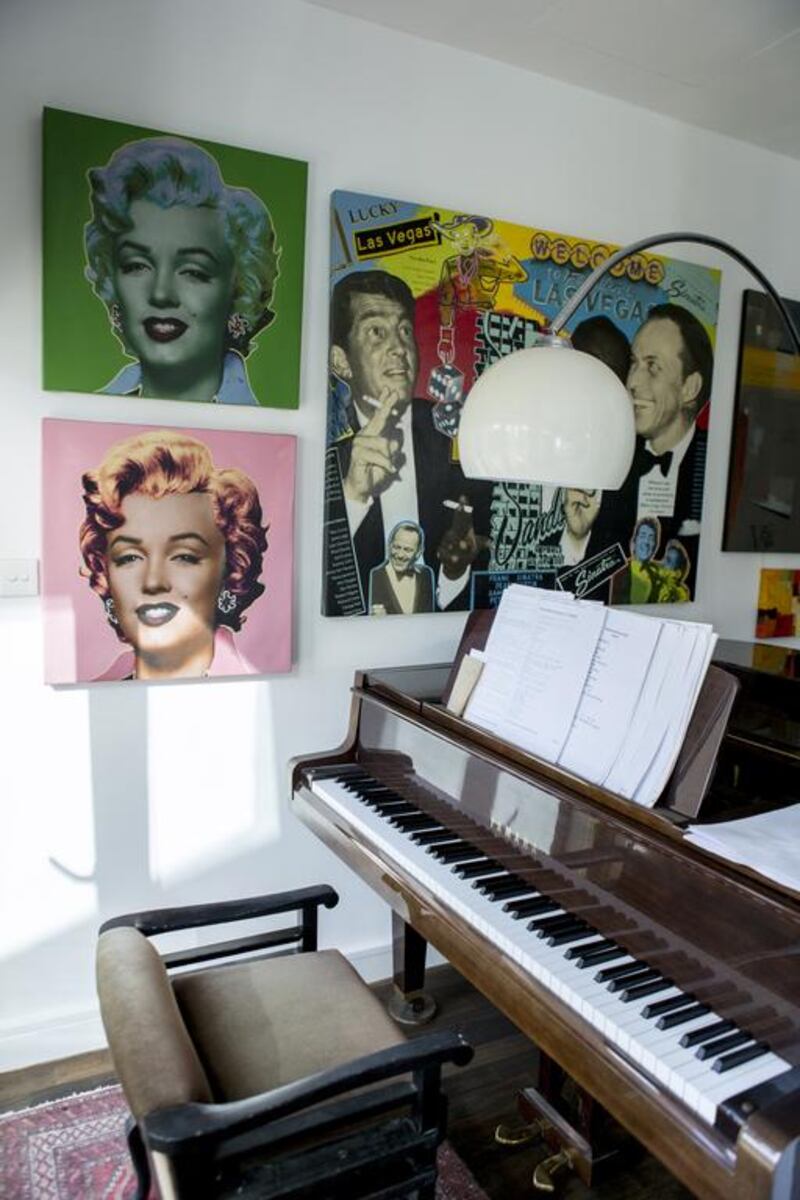 The grand piano, beneath multicoloured pop-art prints, at Judith Hobby's family home. Reem Mohammed / The National
