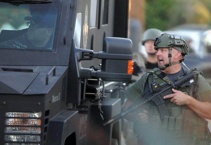 Authorities prepare to search an area near a church on Wednesday, following a shooting that killed multiple people at a social services centre for the disabled in San Bernardino, California. James Quigg / The Victor Valley Daily Press via AP