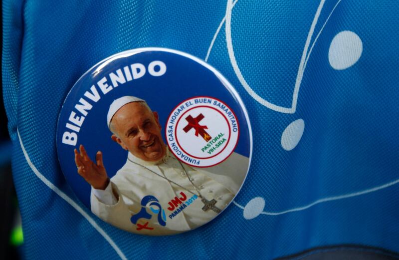 A worshiper wears a pin of Pope Francis. AP Photo