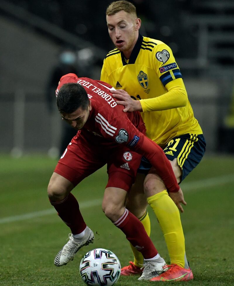 Sweden's Dejan Kulusevski, right, and Guram Giorbelidze of Georgia battle for the ball at the Friends Arena in Stockholm. AP