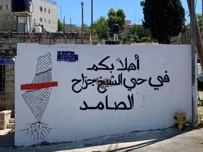 1-	Outside one of the houses in Sheikh Jarrah. The sign reads ‘’Welcome to Sheikh Jarrah, the steadfast neighbourhood.” Zakaria Odeh for The National