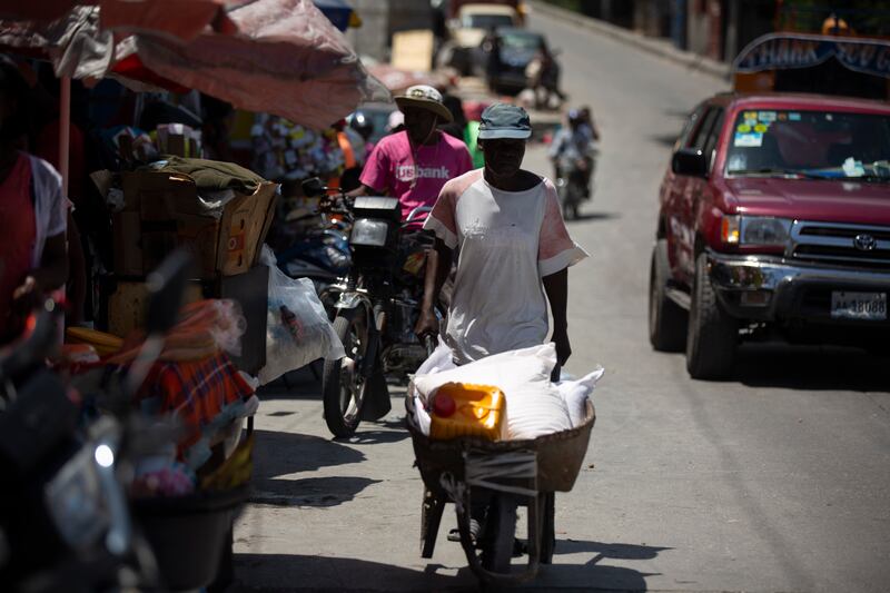 A man pushes a wheelbarrow in Port-au-Prince, Haiti. A 7.2-magnitude earthquake struck the country on Saturday.