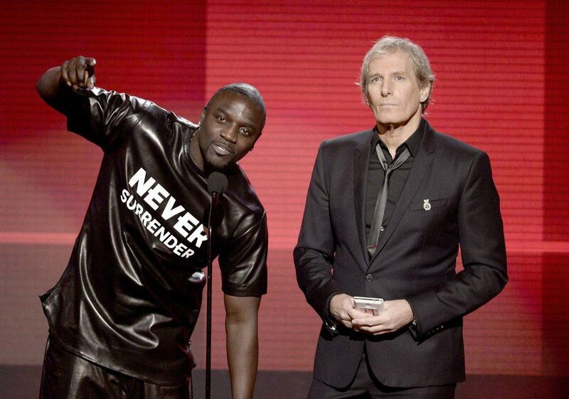 Singers Akon, left, and Michael Bolton speak onstage during the 2013 American Music Awards. Kevin Winter / Getty Images / AFP