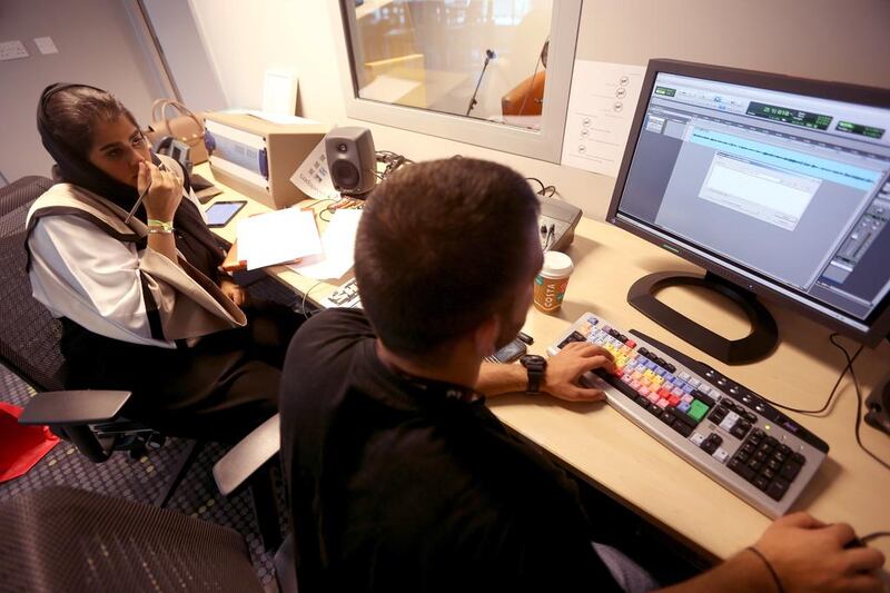 Futaim Al Falasi, left, and Yazen Bakjaji, an audio engineer, record a podcast of Taim Show in Abu Dhabi. Sammy Dallal / The National