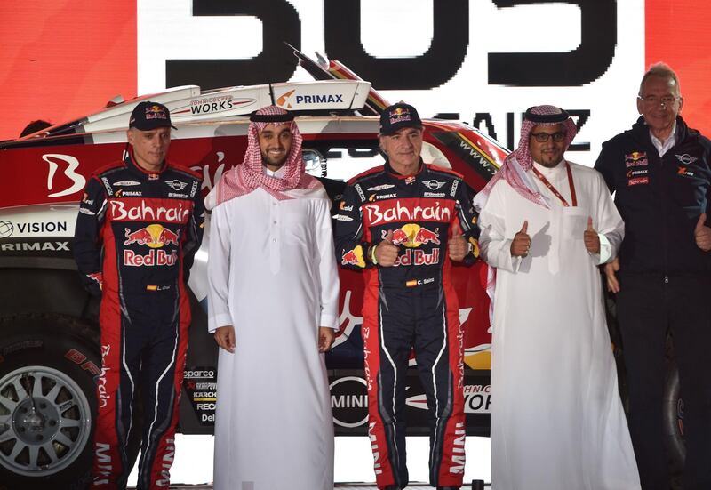 Bahrain JCW X-Raid Team's Spanish driver Carlos Sainz (C) and his Spanish co-driver Lucas Cruz pose for a picture during the podium ceremony in Jeddah. AFP