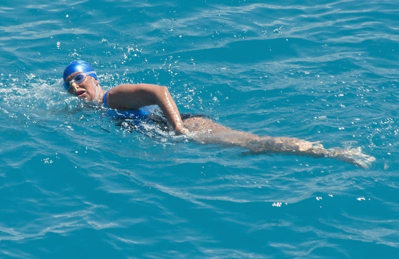 In this photo provided by the Florida Keys News Bureau, Diana Nyad, positioned about two miles off Key West, Fla., Monday, Sept. 2, 2013, swims towards the completion of her 111-mile trek from Cuba to the Florida Keys. Nyad, 64, is be first swimmer to cross the Florida Straits without the security of a shark cage. (AP Photo/Florida Keys Bureau, Andy Newman) *** Local Caption ***  Cuba-Swimming to Florida.JPEG-09ab7.jpg