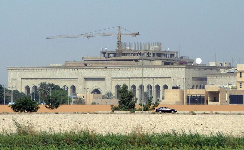 This file photo taken on October 11, 2007 shows in the forefront the US embassy complex in Baghdad and in the background, cranes towering over the construction site of the International High Tribunal (IHT) courthouse, in the heavily fortified Green Zone, on the west bank of the Tigris River in Baghdad. A volley of rockets exploded near the US embassy in Baghdad on December 20,2020, as tensions mount ahead of the anniversary of the US killing of top Iranian general Qasem Soleimani. / AFP / STR
