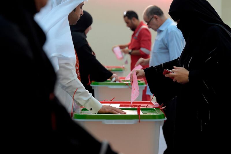 A Bahraini woman places her ballot in a box at a polling centre in Bahrain. AFP