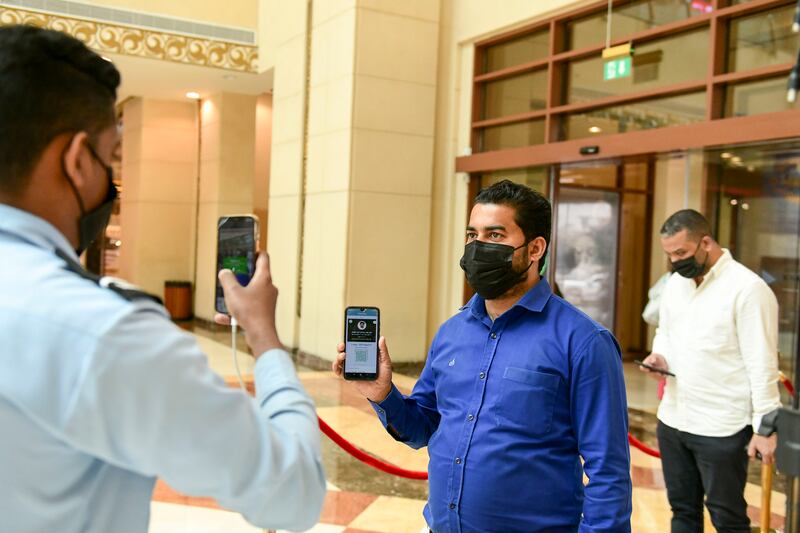 Mandatory checking of the Al Hosn app by security at every entrance of the Khalidiyah Mall in Abu Dhabi.  Khushnum Bhandari / The National
