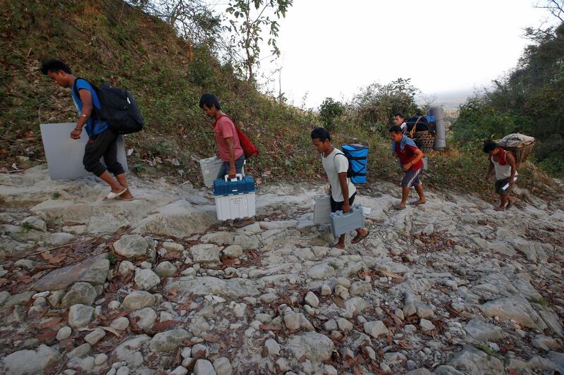 Porters carry Voter Verifiable Paper Audit Trail (VVPAT) machines and Electronic Voting Machines (EVM) through Buxa tiger reserve forest to a remote polling station, in Alipurduar district in the eastern state of West Bengal, India. REUTERS