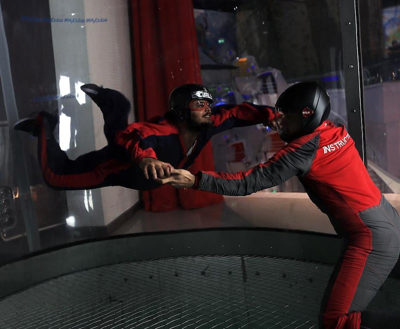 Visitors try the exhilarating iFLY experience at iFLYDubai  at the Mirdiff City Centre . Satish Kumar / The National 