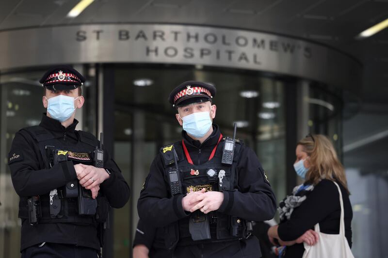 Police officers stand outside St Bartholomew's Hospital. Reuters
