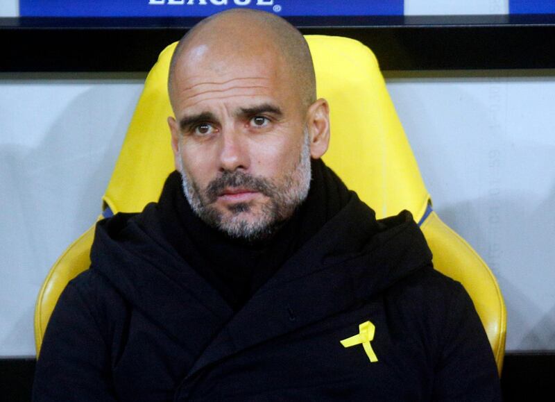 FILE - In this Wednesday, Dec. 6, 2017 file photo, Manchester City coach Josep Guardiola looks on during their Champions League group F soccer match against Shakhtar Donetsk at the Metalist Stadium in Kharkiv, Ukraine. The English Football Association on Friday, Feb. 23, 2018 has charged Manchester City manager Pep Guardiola for promoting a political message by wearing a ribbon to support of imprisoned and ousted pro-independence Catalan politicians. Guardiola was born in Catalonia and is revered in the region because of his links with Barcelona's soccer team, as both a player and coach.(AP Photo/Efrem Lukatsky, file)