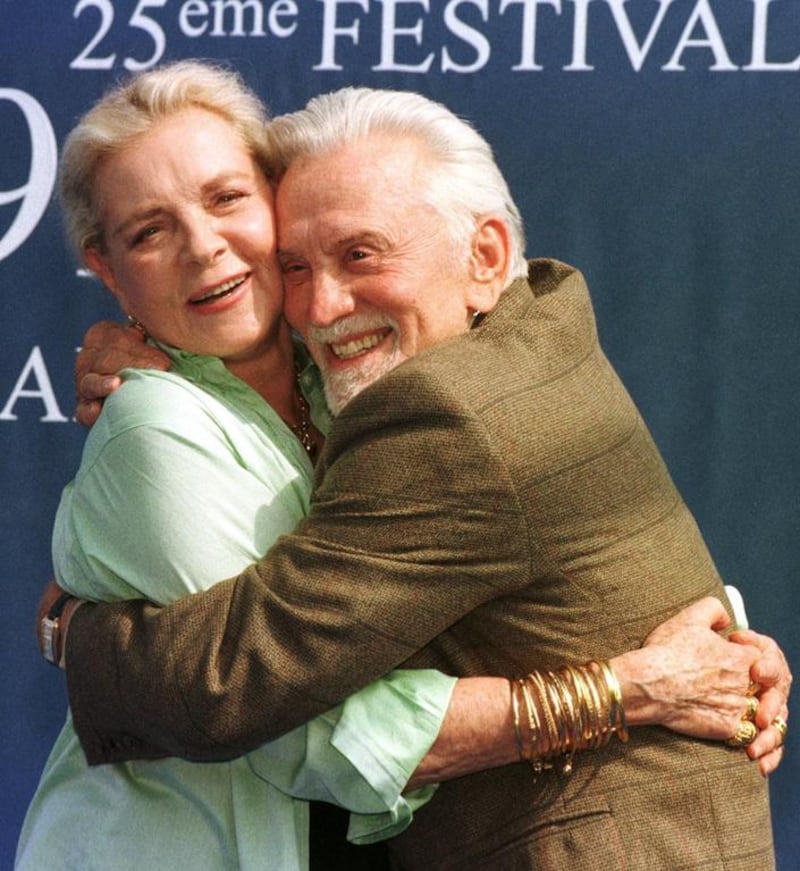 This September 7, 1999 file photo shows Lauren Bacall and Kirk Douglas posing for the photographers prior to their press conference during the 25th American Film Festival in Deauville, France, where they presented their latest film Diamonds.  